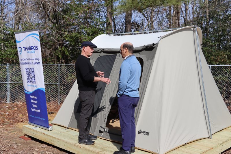 Mike Agnew, Tharros tent village executive director, left, talks to Khalil Saliba, Lewes deputy mayor, in front of one of the new tents March 4. Tharros will be installing 28 tents and platforms between now and May. Organizers said Tharros will open April 1, about two weeks late because of the recent snow. BILL SHULL PHOTOS